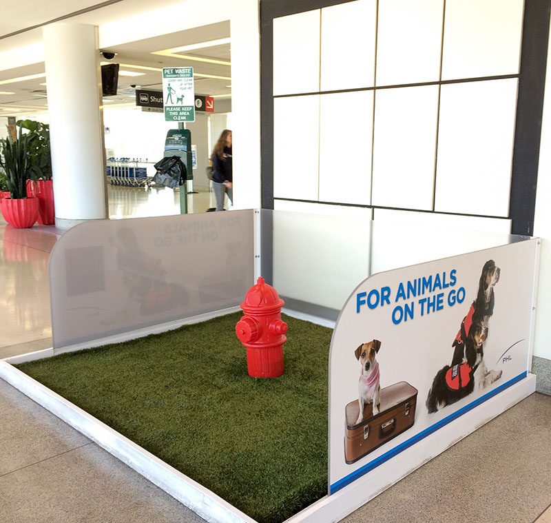 Dog restroom fake grass with fire hydrant in airport